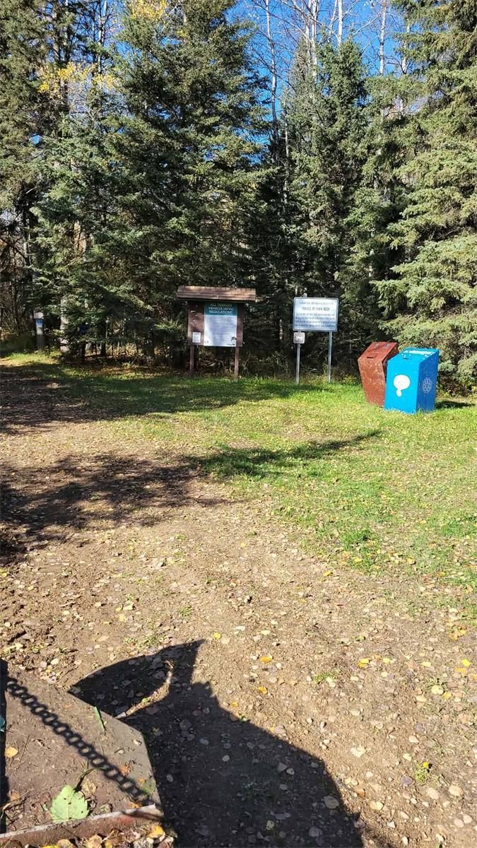 Trailhead board showing ATV regulations and a travel-at-your-own-risk notice
